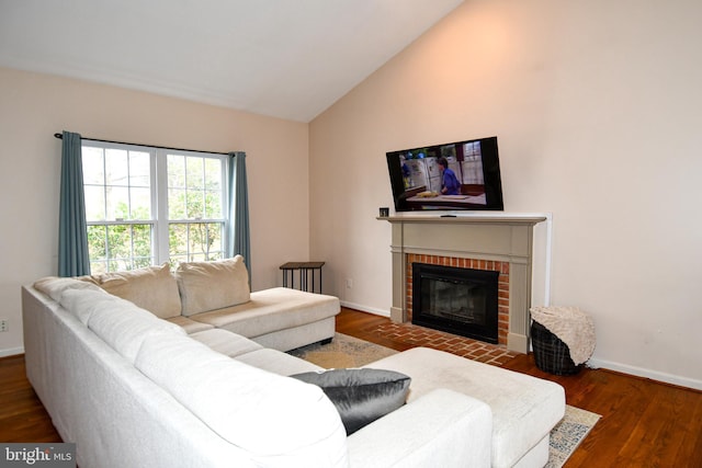 living room featuring a fireplace, baseboards, lofted ceiling, and wood finished floors