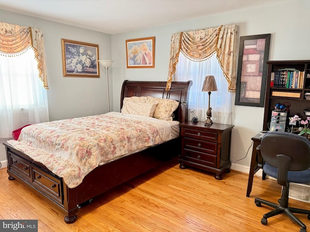 bedroom featuring light wood-type flooring and baseboards