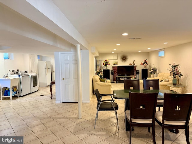 dining area featuring light tile patterned floors, recessed lighting, and separate washer and dryer