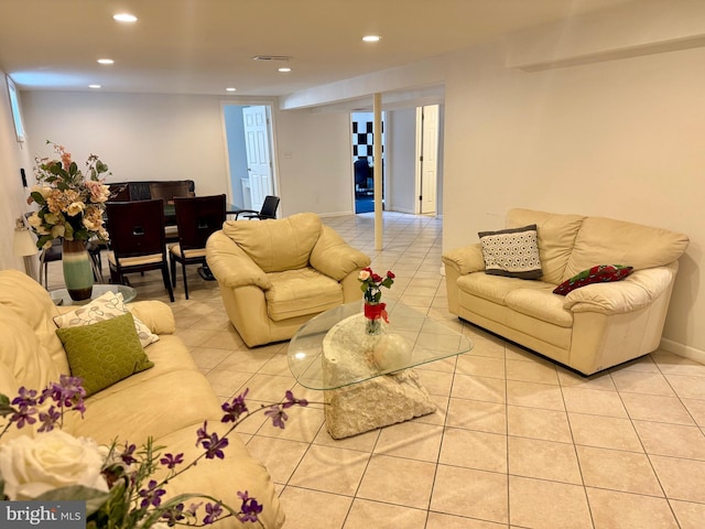 tiled living room with visible vents, recessed lighting, and baseboards