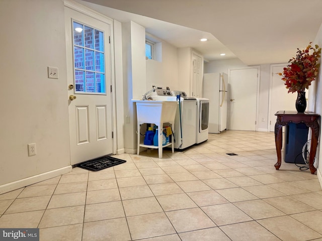 laundry area with light tile patterned floors, baseboards, laundry area, recessed lighting, and washer and dryer