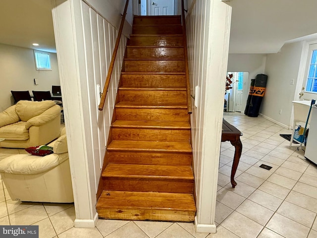 staircase with tile patterned floors and baseboards