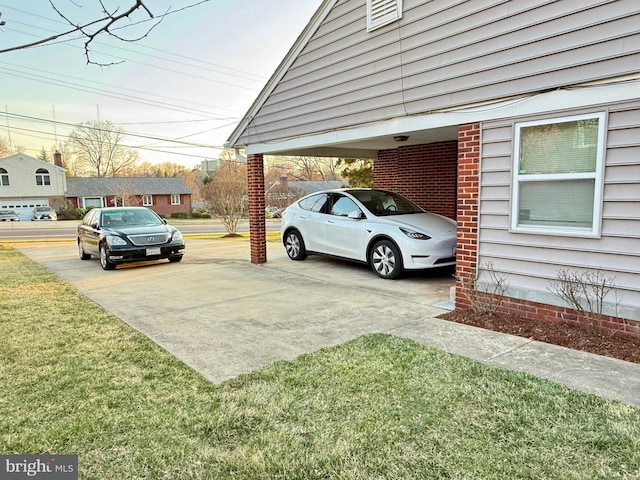 view of parking / parking lot featuring concrete driveway