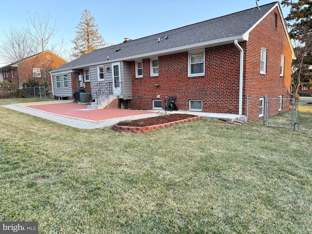 back of house featuring a patio, a gate, fence, a yard, and central air condition unit