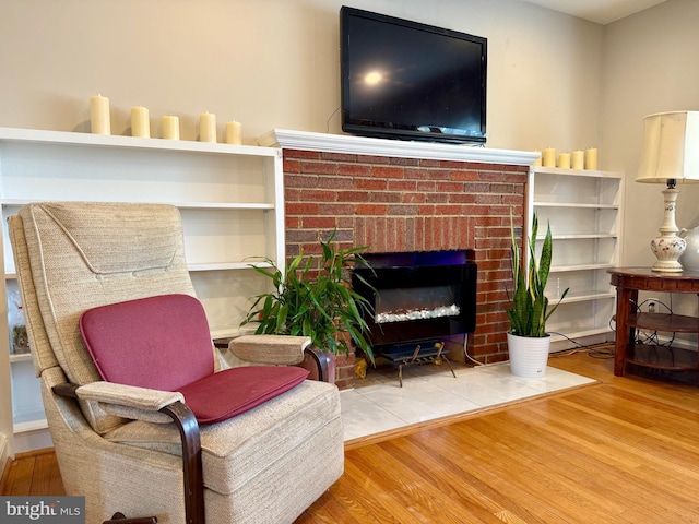 sitting room featuring wood finished floors and a fireplace