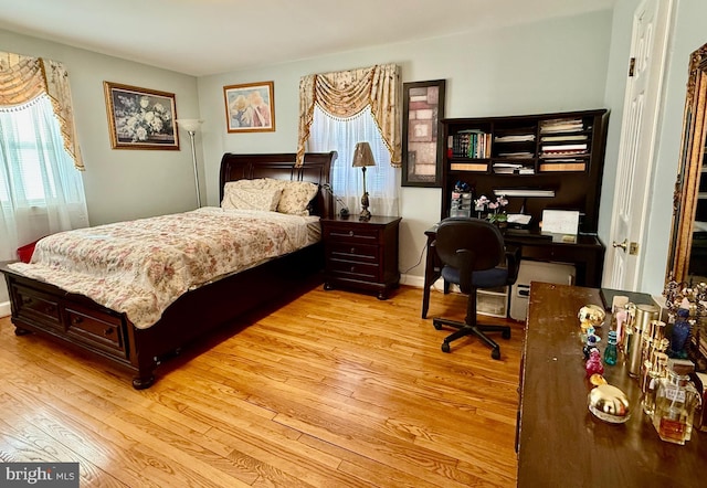 bedroom featuring light wood-style flooring and baseboards