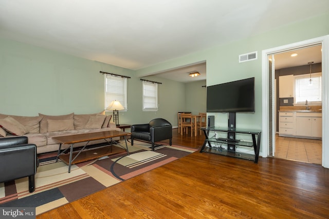 living room with wood finished floors and visible vents