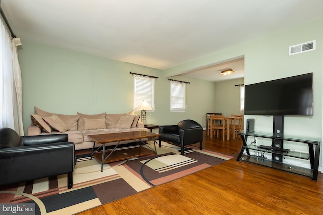 living room with wood finished floors and visible vents