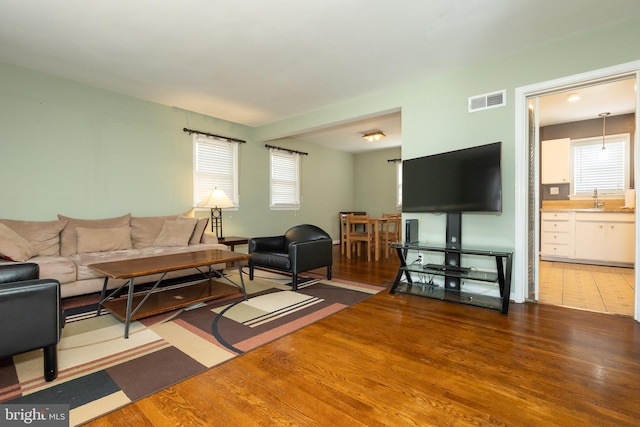 living room with wood finished floors and visible vents