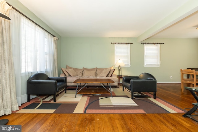 living area with wood finished floors and baseboards