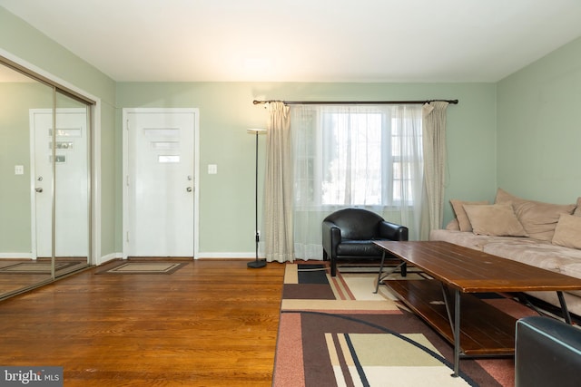 living room with baseboards and wood finished floors