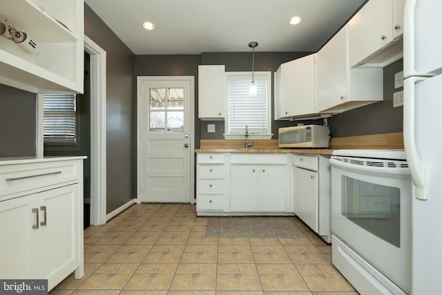 kitchen with white appliances and white cabinets