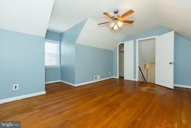 bonus room featuring vaulted ceiling, wood finished floors, and visible vents