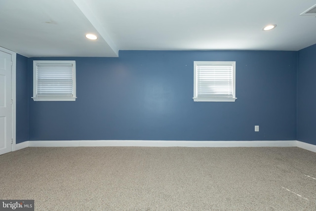 carpeted empty room with recessed lighting, visible vents, and baseboards