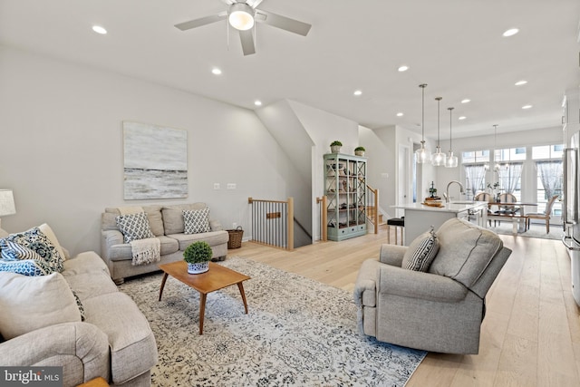 living room featuring recessed lighting, light wood-style flooring, and ceiling fan