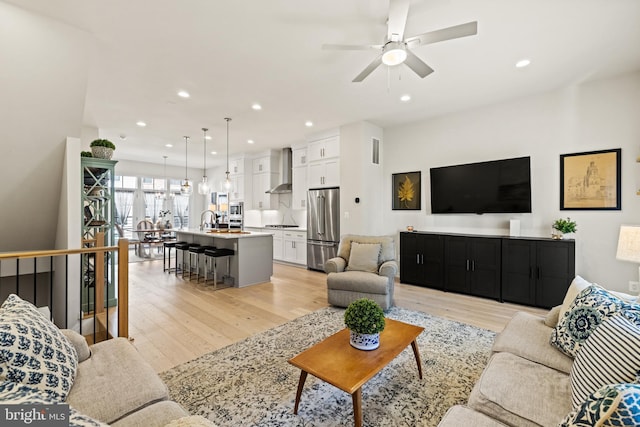 living room featuring recessed lighting, visible vents, ceiling fan, and light wood finished floors