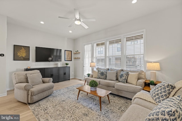 living room with recessed lighting, a ceiling fan, light wood-type flooring, and baseboards