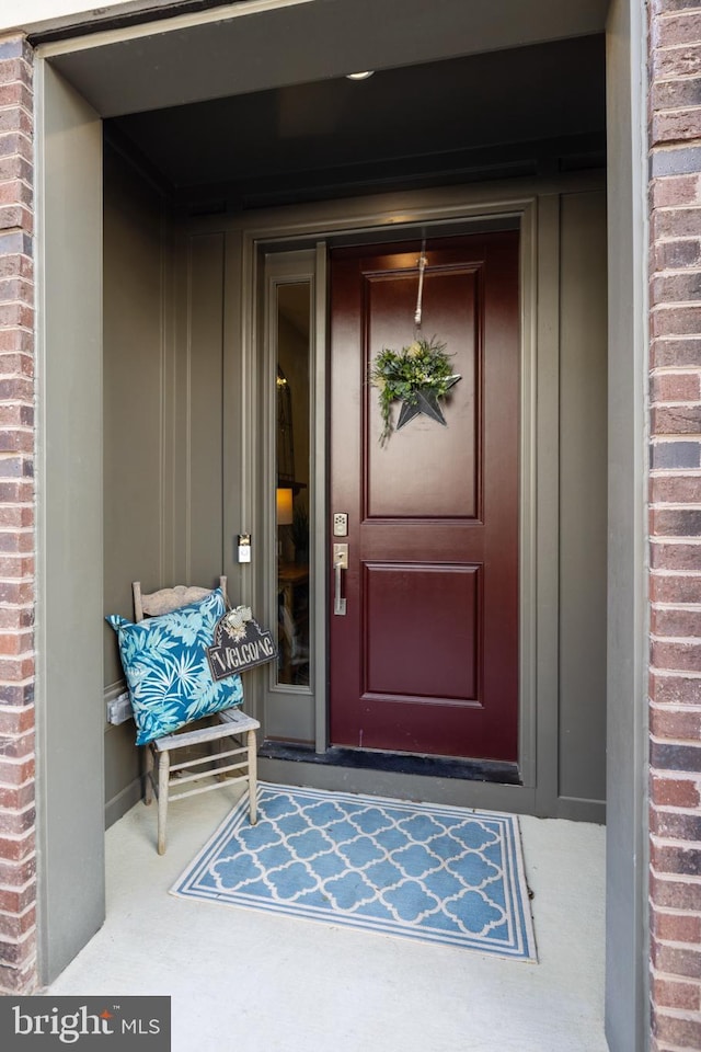 view of exterior entry featuring brick siding