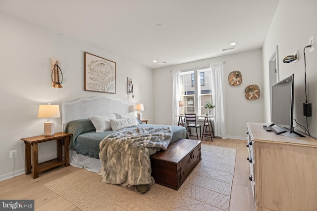 bedroom featuring visible vents, baseboards, and light wood-style floors