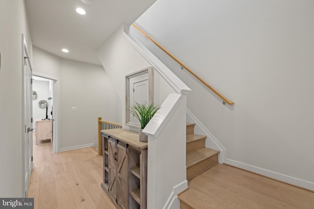 stairs with recessed lighting, wood finished floors, and baseboards