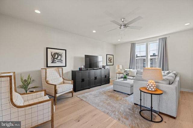 living room featuring recessed lighting, a ceiling fan, light wood-type flooring, and baseboards