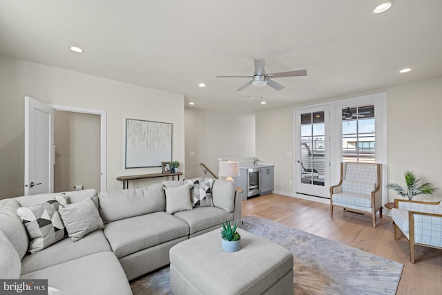 living room featuring recessed lighting, wine cooler, light wood-style floors, and ceiling fan