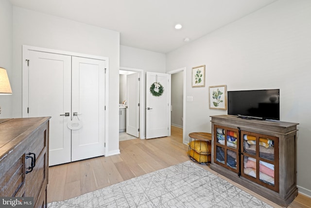 interior space featuring recessed lighting, light wood-type flooring, and baseboards