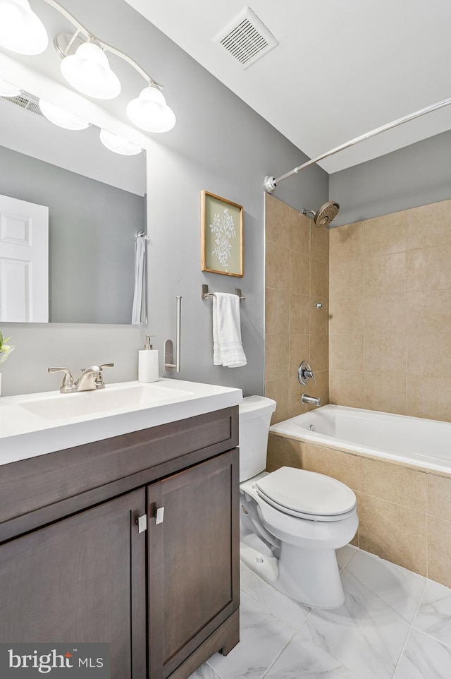 full bathroom featuring vanity, toilet, visible vents, and tiled shower / bath combo