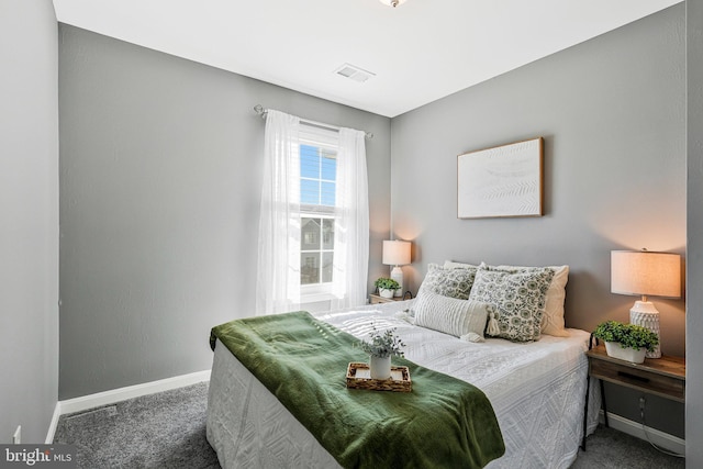 carpeted bedroom featuring visible vents and baseboards