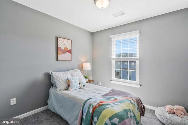 bedroom featuring visible vents, baseboards, and carpet floors