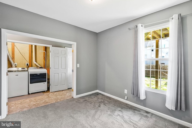 interior space featuring washer and clothes dryer, laundry area, baseboards, and carpet floors