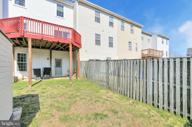 view of yard with a fenced backyard and a wooden deck