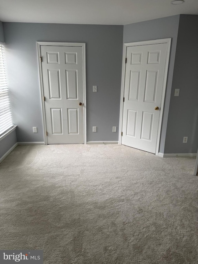 unfurnished bedroom featuring baseboards and carpet floors