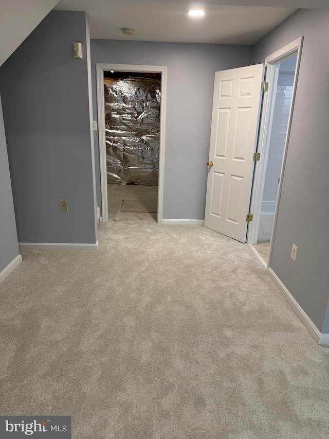 unfurnished bedroom featuring a closet, baseboards, carpet floors, and a spacious closet