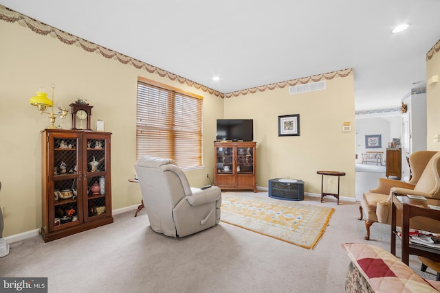 living room with recessed lighting, visible vents, baseboards, and carpet flooring