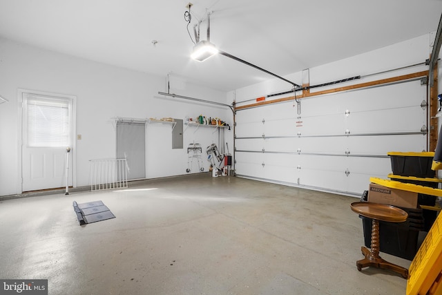 garage with electric panel and a garage door opener