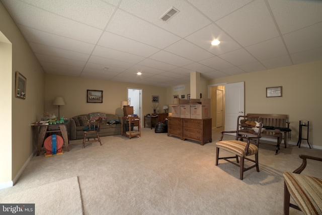 sitting room with visible vents, light colored carpet, a paneled ceiling, and baseboards