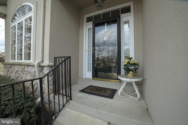 doorway to property with stucco siding