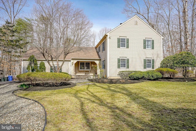 traditional-style home featuring a front lawn