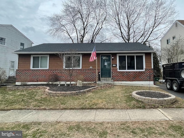 ranch-style house with brick siding and a front yard