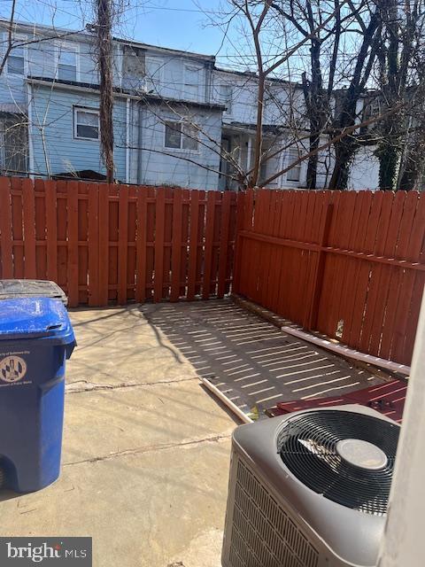 view of patio / terrace featuring central AC unit and fence