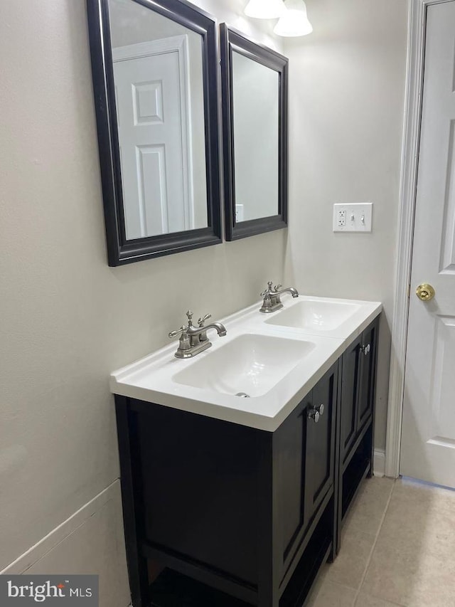 bathroom with tile patterned floors, double vanity, and a sink