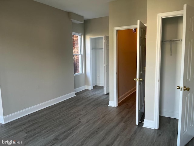 unfurnished bedroom featuring dark wood finished floors and baseboards