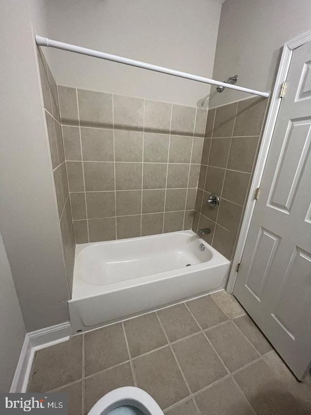 bathroom featuring tile patterned floors, baseboards, and  shower combination