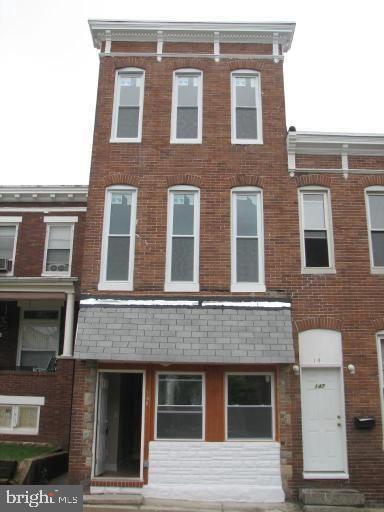 view of property featuring brick siding