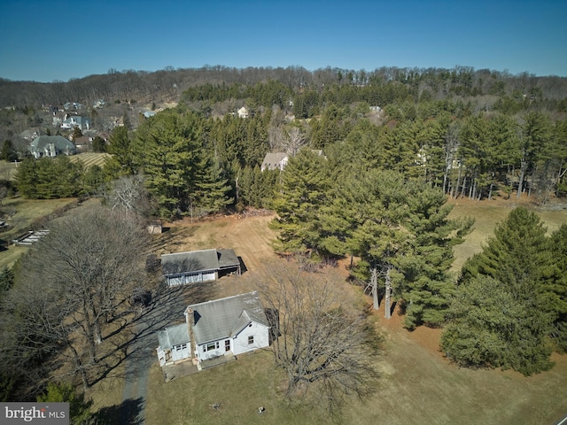 drone / aerial view featuring a wooded view