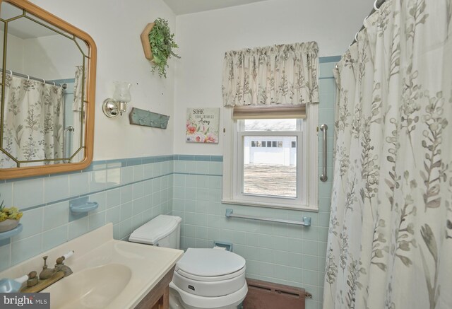 bathroom featuring vanity, toilet, tile walls, and a shower with curtain