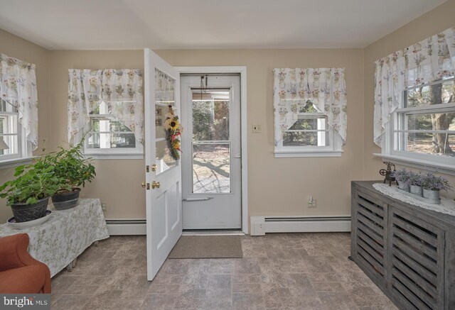 entryway with stone finish flooring and a baseboard radiator