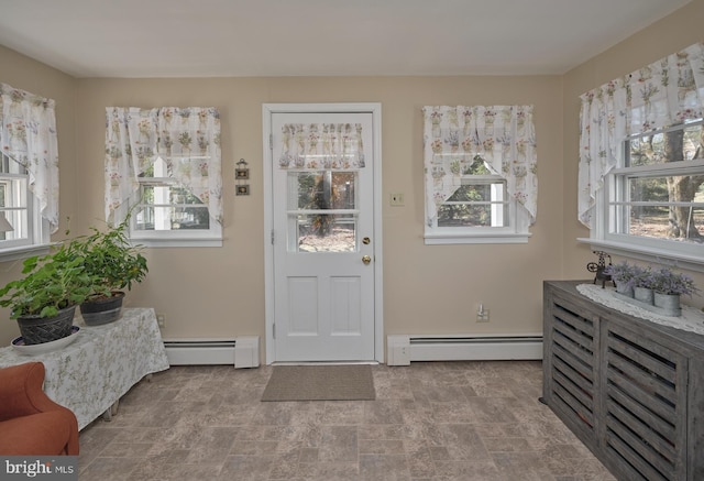 foyer featuring stone finish floor and baseboard heating