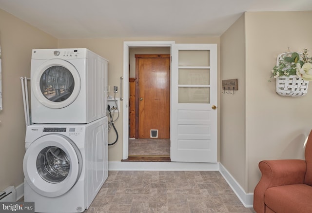 laundry room with visible vents, stacked washer / drying machine, baseboards, baseboard heating, and laundry area